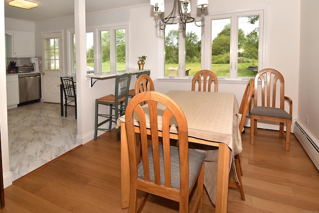 21 Craigmore Rd, Bloomfield, CT 06002 - dining room featuring crown molding, baseboard heating, light wood-style floors, a chandelier, and baseboards