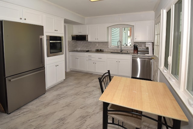 21 Craigmore Rd, Bloomfield, CT 06002 - kitchen featuring appliances with stainless steel finishes, a sink, ornamental molding, backsplash, and white cabinetry