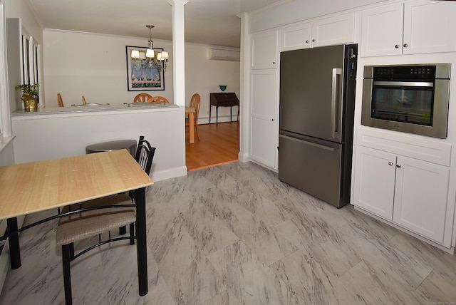 21 Craigmore Rd, Bloomfield, CT 06002 - kitchen featuring stainless steel appliances, white cabinets, a chandelier, and an AC wall unit