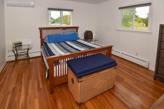 21 Craigmore Rd, Bloomfield, CT 06002 - bedroom featuring a baseboard heating unit, a wall mounted air conditioner, and wood finished floors
