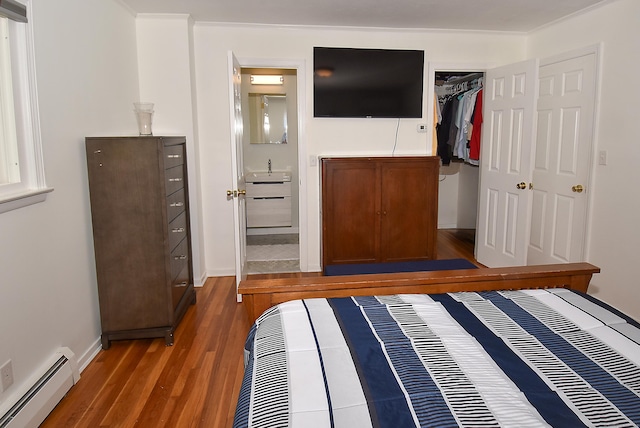 21 Craigmore Rd, Bloomfield, CT 06002 - bedroom with a baseboard heating unit, wood finished floors, a closet, and baseboards