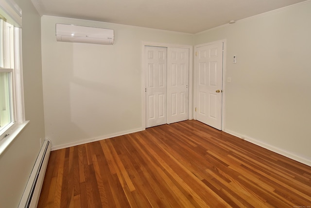 21 Craigmore Rd, Bloomfield, CT 06002 - unfurnished bedroom with a wall mounted air conditioner, a baseboard heating unit, wood finished floors, crown molding, and a closet