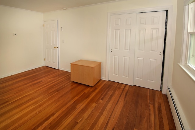 21 Craigmore Rd, Bloomfield, CT 06002 - unfurnished bedroom featuring a baseboard radiator, wood finished floors, a closet, ornamental molding, and baseboards
