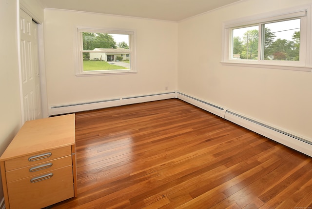 21 Craigmore Rd, Bloomfield, CT 06002 - unfurnished bedroom with multiple windows, crown molding, baseboard heating, wood finished floors, and a closet
