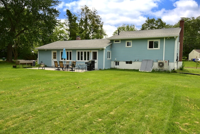 21 Craigmore Rd, Bloomfield, CT 06002 - back of property featuring a chimney, a cooling unit, a patio, and a lawn