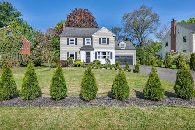 10 Meadowbrook Rd, Hamden, CT 06517 - view of front of home with driveway, a front lawn, an attached garage, and a chimney
