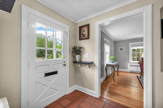 10 Meadowbrook Rd, Hamden, CT 06517 - doorway with radiator heating unit, dark tile patterned floors, crown molding, and baseboards