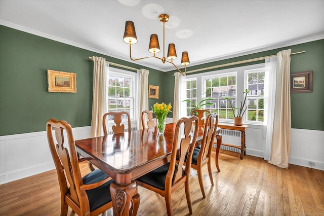 10 Meadowbrook Rd, Hamden, CT 06517 - dining room featuring crown molding, a chandelier, light wood-style floors, radiator, and a wainscoted wall