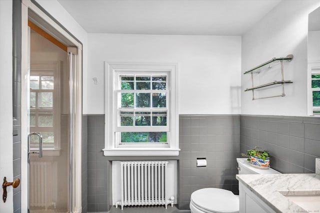 10 Meadowbrook Rd, Hamden, CT 06517 - bathroom featuring radiator, tile walls, a shower stall, toilet, and vanity