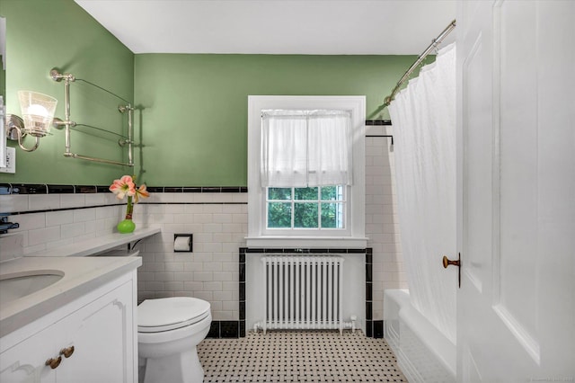 10 Meadowbrook Rd, Hamden, CT 06517 - bathroom with radiator, tile walls, toilet, vanity, and wainscoting
