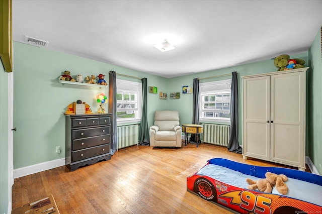 10 Meadowbrook Rd, Hamden, CT 06517 - bedroom with radiator, multiple windows, and wood finished floors