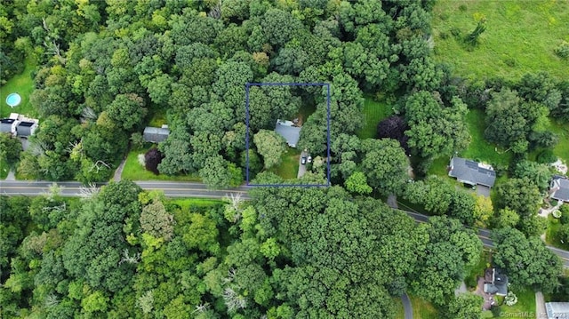 aerial view of property and surrounding area featuring property parcel outlined