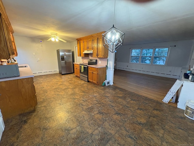 kitchen featuring stainless steel appliances, a baseboard heating unit, brown cabinets, under cabinet range hood, and open floor plan