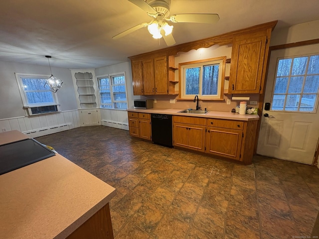 kitchen with black dishwasher, baseboard heating, a sink, brown cabinetry, and a wainscoted wall