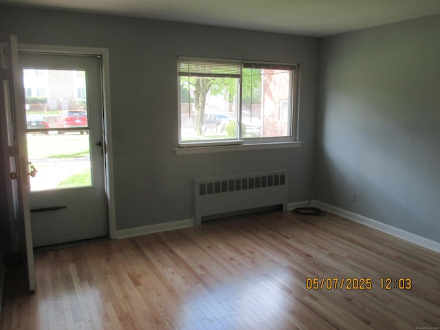 51-71 Park Ave Unit 3-21, Danbury, CT 06810 - entryway featuring radiator, wood finished floors, and baseboards