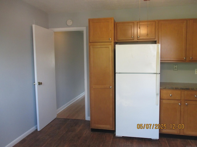 51-71 Park Ave Unit 3-21, Danbury, CT 06810 - kitchen featuring freestanding refrigerator, dark wood finished floors, baseboards, and brown cabinets