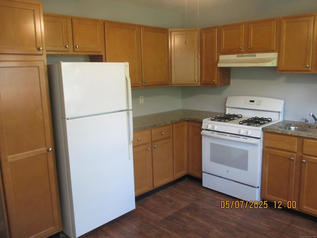 51-71 Park Ave Unit 3-21, Danbury, CT 06810 - kitchen with white appliances, under cabinet range hood, a sink, dark wood finished floors, and dark countertops