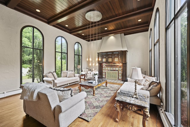 46 Mountain Farms Rd, West Hartford, CT 06117 - living area featuring a textured wall, wooden ceiling with exposed beams, wood finished floors, a fireplace, and baseboard heating