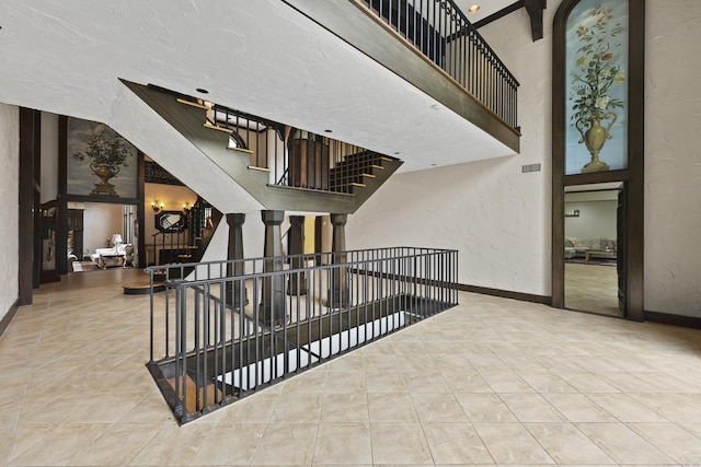 46 Mountain Farms Rd, West Hartford, CT 06117 - stairs featuring tile patterned floors, a textured wall, and baseboards