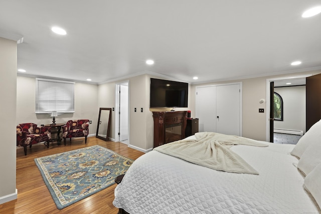 46 Mountain Farms Rd, West Hartford, CT 06117 - bedroom featuring a baseboard heating unit, recessed lighting, wood finished floors, crown molding, and baseboards