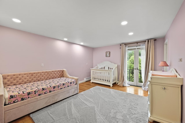 46 Mountain Farms Rd, West Hartford, CT 06117 - bedroom with recessed lighting, wood finished floors, access to exterior, and a baseboard radiator