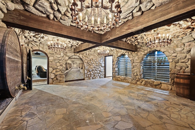 46 Mountain Farms Rd, West Hartford, CT 06117 - unfurnished living room featuring a chandelier, stone floors, beamed ceiling, and arched walkways
