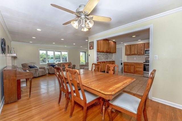 dining space featuring crown molding, a ceiling fan, light wood-type flooring, recessed lighting, and baseboards