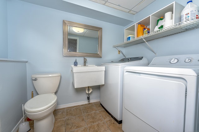 washroom with separate washer and dryer and baseboards