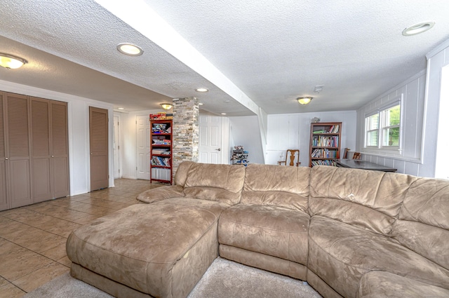 living area featuring a textured ceiling, tile patterned flooring, and recessed lighting