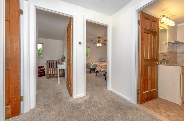 hallway featuring light carpet