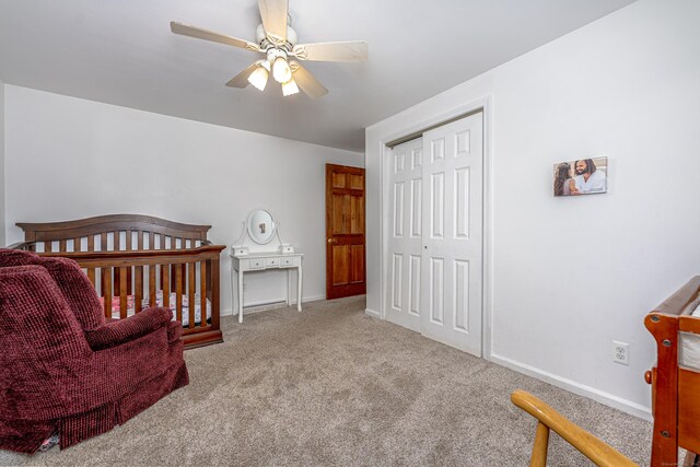 bedroom with carpet, a closet, baseboards, and ceiling fan