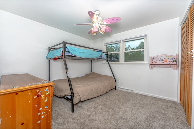 bedroom featuring carpet, a closet, a ceiling fan, a baseboard heating unit, and baseboards
