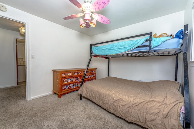 carpeted bedroom with baseboards and ceiling fan