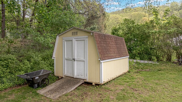 view of shed with a forest view