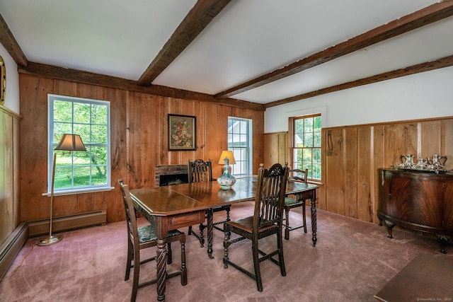 home office featuring wood walls, carpet, beam ceiling, and a fireplace