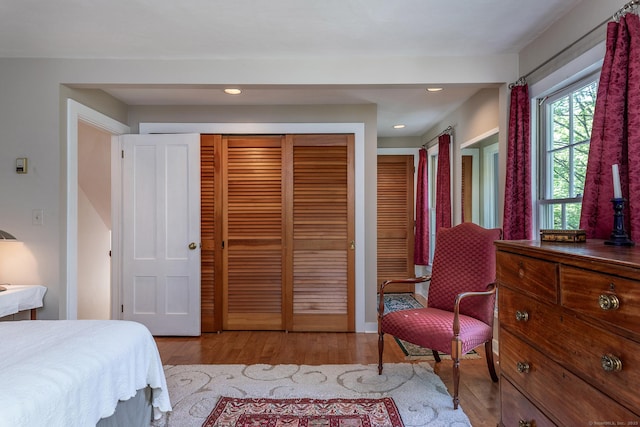 bedroom featuring a closet, wood finished floors, and recessed lighting