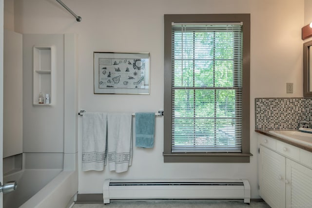 full bath with baseboard heating, plenty of natural light, vanity, and backsplash