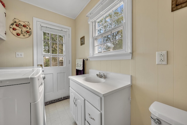 4 Hockanum Dr, East Hartford, CT 06118 - laundry area with healthy amount of natural light, independent washer and dryer, ornamental molding, and a decorative wall