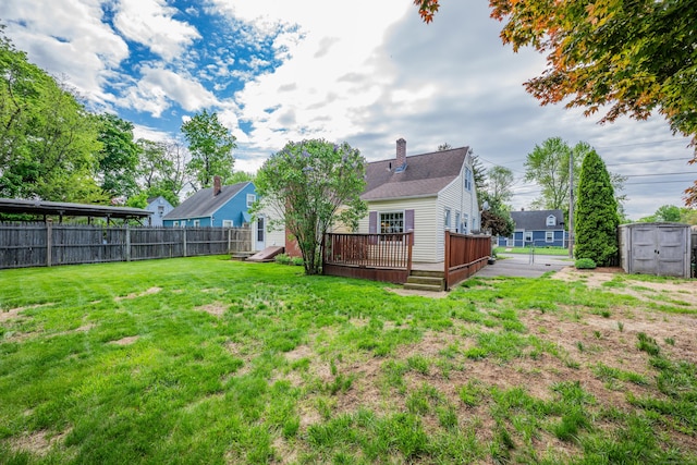 4 Hockanum Dr, East Hartford, CT 06118 - rear view of house with a deck, a storage shed, and a chimney