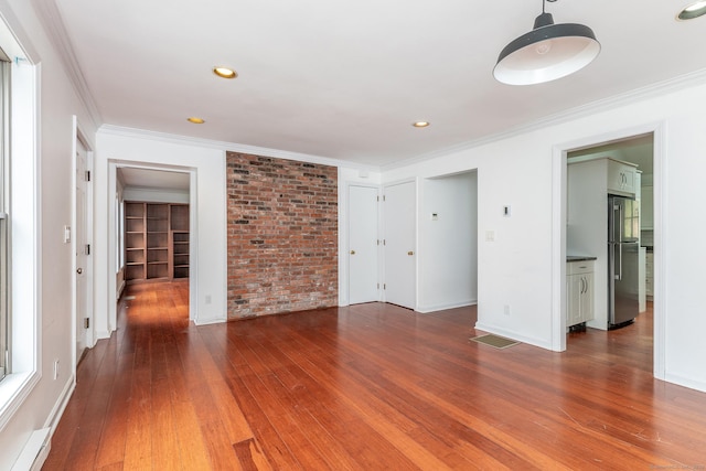433 Kent Cornwall Rd Unit 14, Kent, CT 06757 - unfurnished living room with hardwood / wood-style floors, crown molding, recessed lighting, brick wall, and baseboards