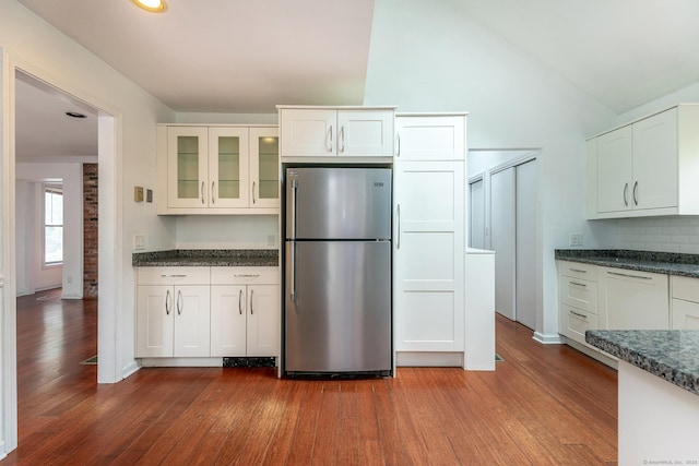 433 Kent Cornwall Rd Unit 14, Kent, CT 06757 - kitchen featuring freestanding refrigerator, dark wood-type flooring, glass insert cabinets, lofted ceiling, and white cabinetry