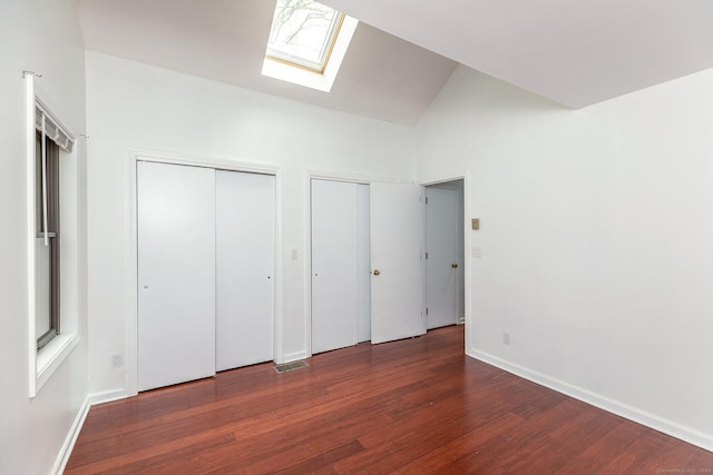 433 Kent Cornwall Rd Unit 14, Kent, CT 06757 - unfurnished bedroom with a skylight, two closets, lofted ceiling, wood finished floors, and baseboards
