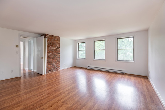 433 Kent Cornwall Rd Unit 14, Kent, CT 06757 - spare room featuring baseboard heating, healthy amount of natural light, wood finished floors, and baseboards