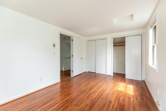 433 Kent Cornwall Rd Unit 14, Kent, CT 06757 - unfurnished bedroom featuring multiple closets, wood finished floors, and baseboards