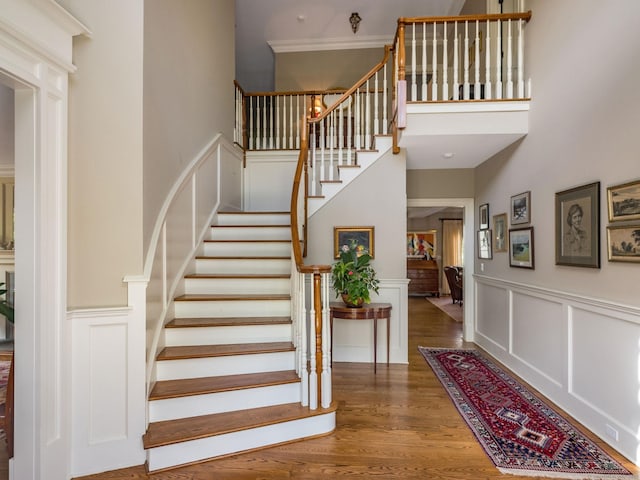 37 Lantern Hill Rd, Madison, CT 06443 - stairway with a towering ceiling, wood finished floors, a decorative wall, and wainscoting