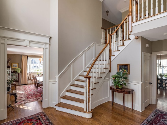 37 Lantern Hill Rd, Madison, CT 06443 - stairs with plenty of natural light, wood finished floors, a high ceiling, a decorative wall, and a wainscoted wall