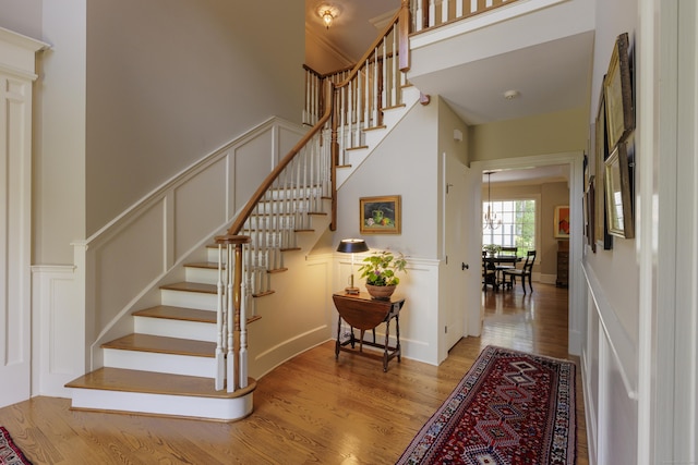 37 Lantern Hill Rd, Madison, CT 06443 - stairs featuring wood finished floors, a high ceiling, and a decorative wall