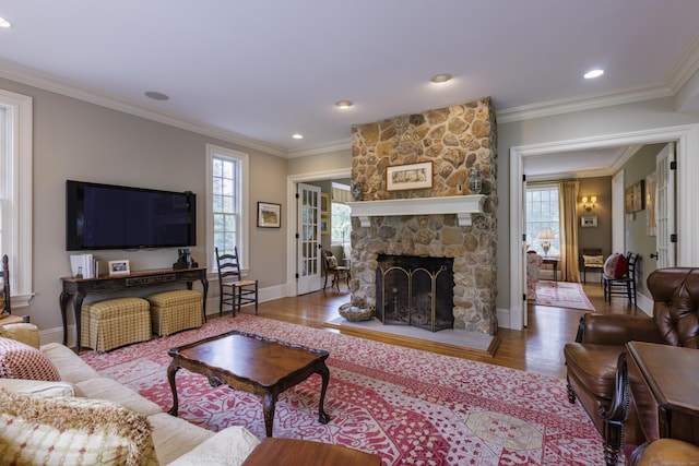37 Lantern Hill Rd, Madison, CT 06443 - living area with wood finished floors, a stone fireplace, crown molding, and recessed lighting
