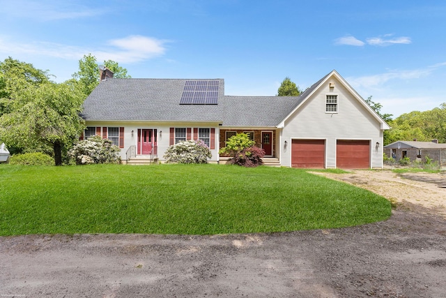 241 New London Rd, Colchester, CT 06415 - view of front of property featuring driveway, roof mounted solar panels, a front yard, a shingled roof, and a chimney