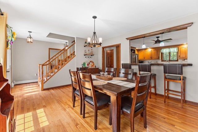 241 New London Rd, Colchester, CT 06415 - dining area with stairs, a baseboard heating unit, light wood-style flooring, a ceiling fan, and a chandelier